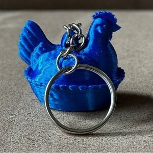 Blue hen on nest Keychain
